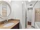 A bathroom features a granite-topped vanity and shower with decorative tile at 4021 Hargill Dr, Orlando, FL 32806