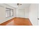 A bright bedroom with hardwood floors, a ceiling fan, a window, and a closet at 4021 Hargill Dr, Orlando, FL 32806
