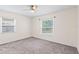 Well-lit bedroom featuring a neutral paint color, carpet floor and two windows providing ample light at 4021 Hargill Dr, Orlando, FL 32806