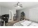 Comfortable bedroom with a ceiling fan, neutral paint, a desk for workspace and an attached bathroom for convenience at 4021 Hargill Dr, Orlando, FL 32806