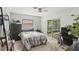 Bedroom with a sliding door leading to the screened-in porch and a grey dresser with a shark plushy at 4021 Hargill Dr, Orlando, FL 32806