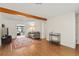 Bright living room with hardwood floors, wooden beam, and area rug, creating a warm and inviting space at 4021 Hargill Dr, Orlando, FL 32806