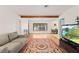 Cozy living room with hardwood flooring, open to dining area and featuring a comfortable sofa at 4021 Hargill Dr, Orlando, FL 32806