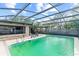 Spacious screened-in pool with ample seating and patio space, surrounded by lush greenery for privacy at 4021 Hargill Dr, Orlando, FL 32806