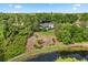 Aerial view of home, backyard, and pond, surrounded by lush greenery and trees at 4065 Winderlakes Dr, Orlando, FL 32835