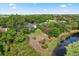 Aerial view of the home featuring a pond and lush landscaping at 4065 Winderlakes Dr, Orlando, FL 32835