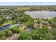 Stunning aerial view of a home surrounded by lush greenery and a serene lakefront, showcasing picturesque natural beauty at 4065 Winderlakes Dr, Orlando, FL 32835