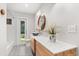 Well-lit bathroom featuring modern vanity, vessel sink, wood accents and decorative plant at 4065 Winderlakes Dr, Orlando, FL 32835