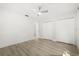 Bright bedroom with light wood floors, ceiling fan, and white closet doors at 4065 Winderlakes Dr, Orlando, FL 32835