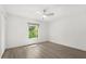 Minimalist bedroom with natural light, featuring a modern ceiling fan at 4065 Winderlakes Dr, Orlando, FL 32835