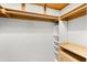 Walk-in closet with custom shelving and wood rods for organizing clothing at 4065 Winderlakes Dr, Orlando, FL 32835