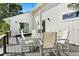Exterior deck area with outdoor seating, table, umbrella and sliding glass door at 4065 Winderlakes Dr, Orlando, FL 32835