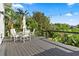 Outdoor deck features a dining table set among tropical foliage and string lights at 4065 Winderlakes Dr, Orlando, FL 32835