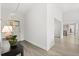 Inviting foyer with hardwood floors and a console table with a decorative lamp and plant at 4065 Winderlakes Dr, Orlando, FL 32835