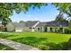 A well-manicured lawn complements this beautiful single-story home with a dark roof and white trim at 4065 Winderlakes Dr, Orlando, FL 32835