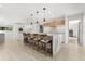 Modern kitchen with island seating, sleek countertops, and white cabinets, creating a stylish cooking space at 4065 Winderlakes Dr, Orlando, FL 32835
