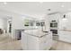 Modern kitchen featuring a marble island, stainless steel appliances, and a wine cooler at 4065 Winderlakes Dr, Orlando, FL 32835
