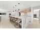 Open kitchen showcasing a spacious island with marble countertop, wooden chairs and stainless steel appliances at 4065 Winderlakes Dr, Orlando, FL 32835