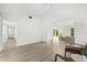 Bright, open living room with light wood floors and high ceilings create an airy, inviting space at 4065 Winderlakes Dr, Orlando, FL 32835