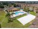 Aerial view featuring a pool, volleyball court, and surrounding buildings, displaying outdoor amenities and green spaces at 419 Terrace Ridge Cir # 419, Davenport, FL 33896