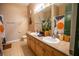 Well-lit bathroom featuring a double vanity, large mirror, and modern fixtures at 419 Terrace Ridge Cir # 419, Davenport, FL 33896