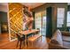 Stylish dining area featuring a unique textured wall, tropical wallpaper, and sliding glass doors to a balcony at 419 Terrace Ridge Cir # 419, Davenport, FL 33896