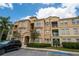 Multi-story condo with a peach facade and parking at 419 Terrace Ridge Cir # 419, Davenport, FL 33896