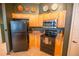 Kitchen featuring a black refrigerator and modern appliances at 419 Terrace Ridge Cir # 419, Davenport, FL 33896