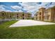 Exterior view of a sand volleyball court, part of the community's amenities, with residential buildings in the background at 419 Terrace Ridge Cir # 419, Davenport, FL 33896