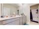 A well-lit bathroom featuring double sinks and a shower at 4191 Holstein St, St Cloud, FL 34772