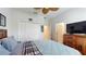 A well-lit bedroom features a ceiling fan, closet, and dresser at 4191 Holstein St, St Cloud, FL 34772