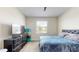 A bedroom with a window, carpeted floor, and stylish black dresser at 4191 Holstein St, St Cloud, FL 34772