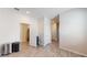 A spacious hallway with wood-look tile flooring and multiple doorways at 4191 Holstein St, St Cloud, FL 34772