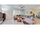 Spacious living room with tile flooring, modern lighting, and a comfortable sectional sofa at 4191 Holstein St, St Cloud, FL 34772