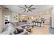 Open-concept living and dining area with a kitchen island and modern bar stools at 4191 Holstein St, St Cloud, FL 34772