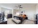 A stylish bedroom featuring a ceiling fan and a comfortable bed at 4191 Holstein St, St Cloud, FL 34772