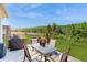 Outdoor dining on the backyard patio amidst lush landscaping and verdant lawn at 4191 Holstein St, St Cloud, FL 34772