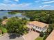 Stunning aerial view of the home, landscaping and serene lake at 4509 Patricia Ann Ct, Orlando, FL 32839