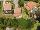 Aerial view of this home showcasing the Spanish tile roof, lush landscaping, and waterfront access at 4509 Patricia Ann Ct, Orlando, FL 32839