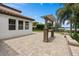 Lovely paved back patio, with custom outdoor stone bar, landscaping and partial water view at 4509 Patricia Ann Ct, Orlando, FL 32839