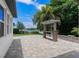 Backyard area featuring a bar, stone pavers, and a scenic lake view at 4509 Patricia Ann Ct, Orlando, FL 32839