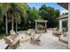 Outdoor seating area with a fire pit, bar and grill, and lush greenery at 4509 Patricia Ann Ct, Orlando, FL 32839