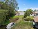 Lush backyard featuring a private dock, boat lift, and direct access to the serene lake at 4509 Patricia Ann Ct, Orlando, FL 32839