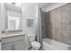 Neutral bathroom with a tub, tiled shower, granite vanity, and a framed mirror at 4509 Patricia Ann Ct, Orlando, FL 32839