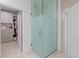 Modern bathroom featuring a glass shower with frosted privacy panel and access to a walk-in closet at 4509 Patricia Ann Ct, Orlando, FL 32839