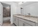 Bathroom featuring double sinks with granite countertops and neutral cabinets at 4509 Patricia Ann Ct, Orlando, FL 32839