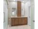 A stylish bathroom features double sink vanity with wood cabinets, stone countertops, and gold fixtures at 4509 Patricia Ann Ct, Orlando, FL 32839