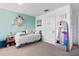 Bedroom decorated with paper butterflies, teal walls, and cozy furniture at 4509 Patricia Ann Ct, Orlando, FL 32839