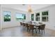 Bright dining room with large windows offering beautiful water views, and stylish light fixture at 4509 Patricia Ann Ct, Orlando, FL 32839