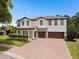 Beautiful two-story home featuring a brick driveway and a well-manicured lawn at 4509 Patricia Ann Ct, Orlando, FL 32839